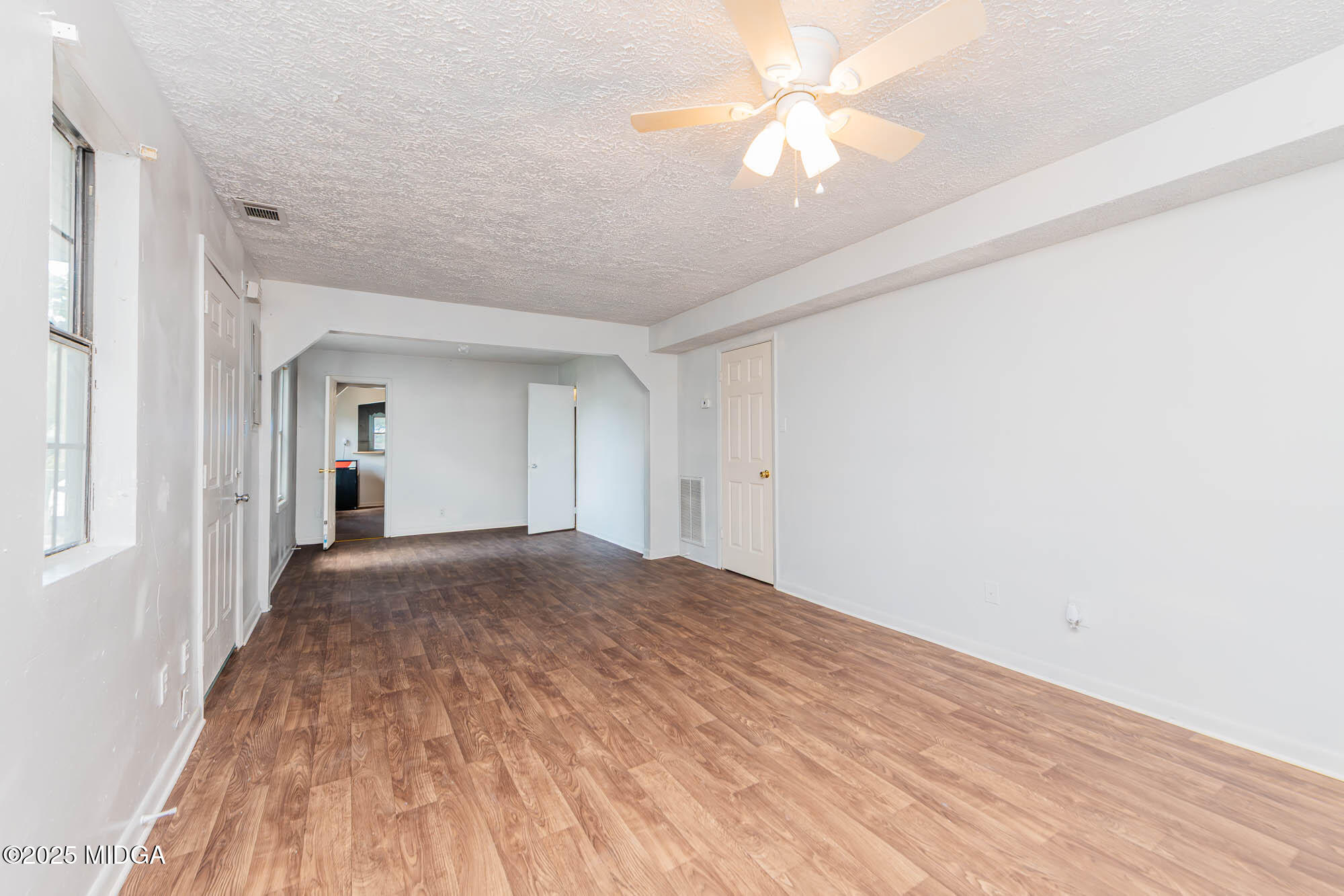 125 Suzanne Drive Warner Robins, GA 31093 - Photo 14 of 50 a view of empty room with wooden floor and fan