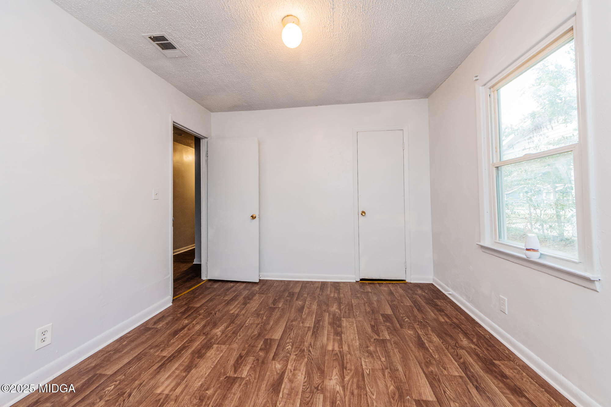 125 Suzanne Drive Warner Robins, GA 31093 - Photo 21 of 50 a view of empty room with wooden floor and fan