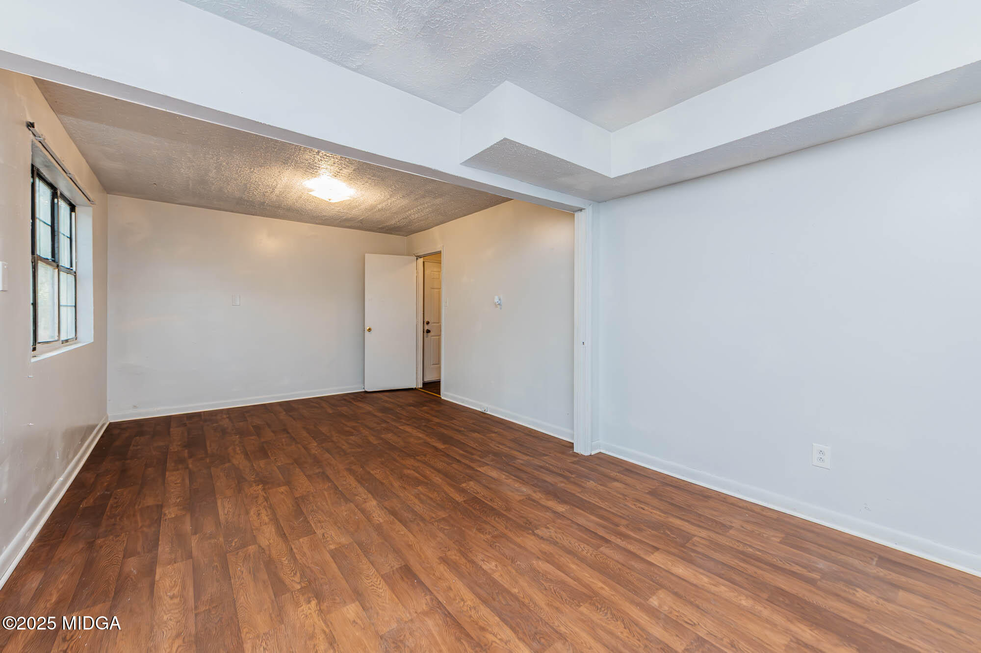 125 Suzanne Drive Warner Robins, GA 31093 - Photo 27 of 50 a view of empty room with wooden floor and fan