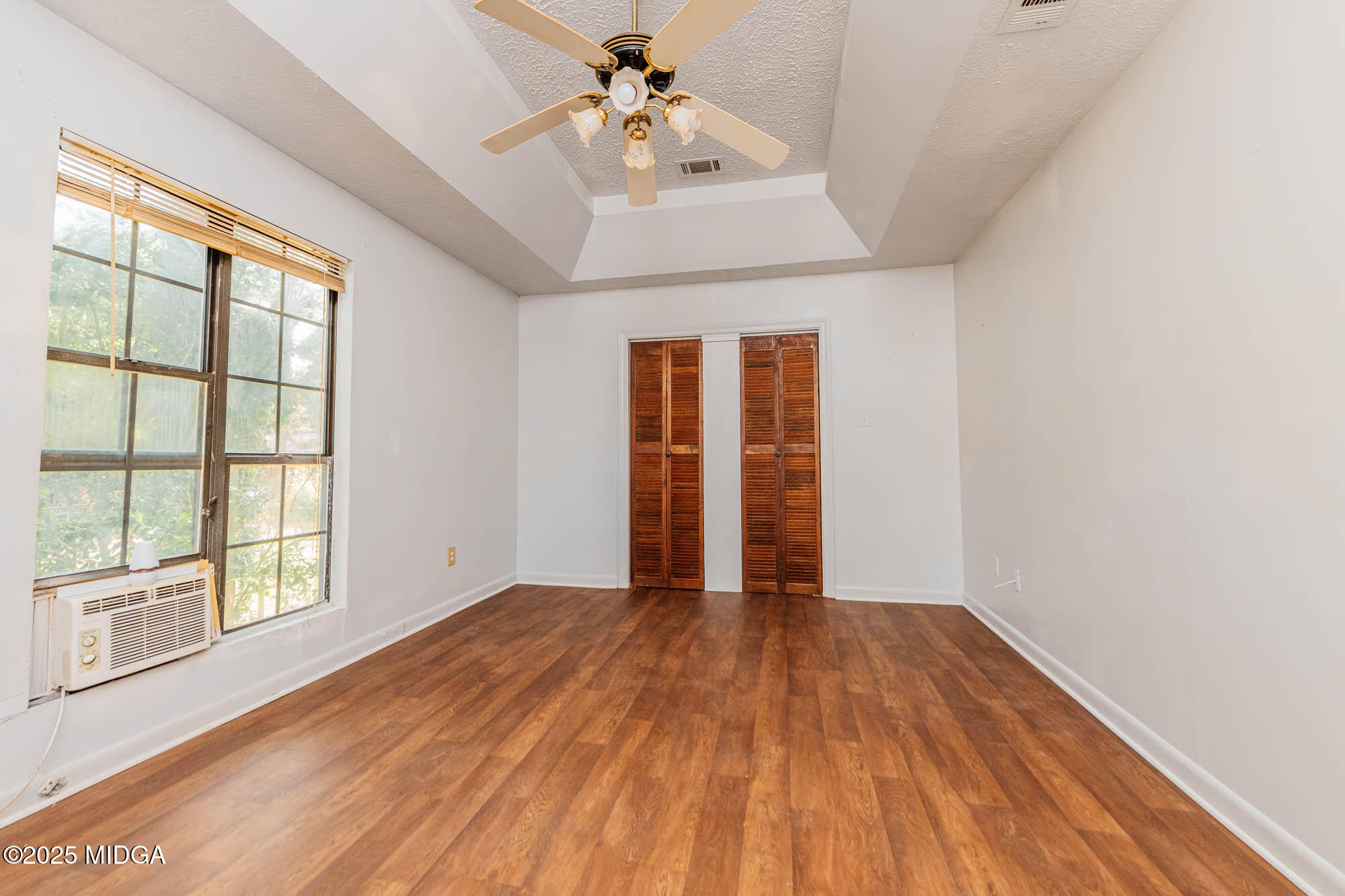 125 Suzanne Drive Warner Robins, GA 31093 - Photo 39 of 50 a view of an empty room with a window and wooden floor
