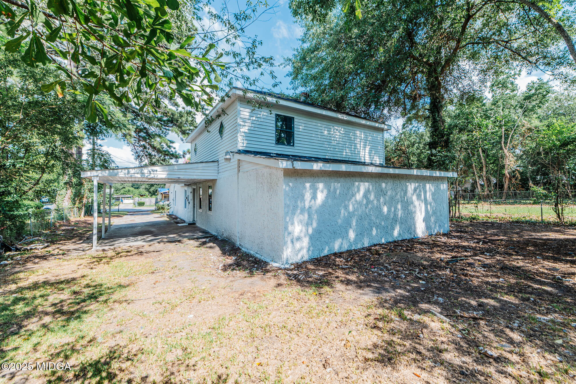 125 Suzanne Drive Warner Robins, GA 31093 - Photo 4 of 50 a view of a small house with yard and a tree
