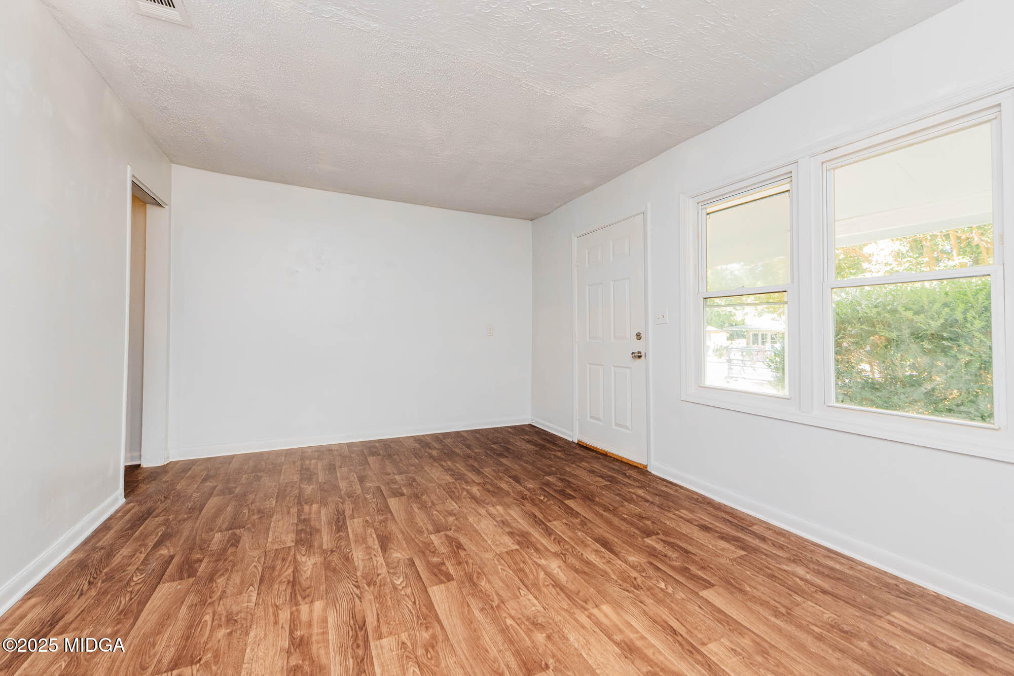 125 Suzanne Drive Warner Robins, GA 31093 - Photo 6 of 50 a view of empty room with wooden floor and fan