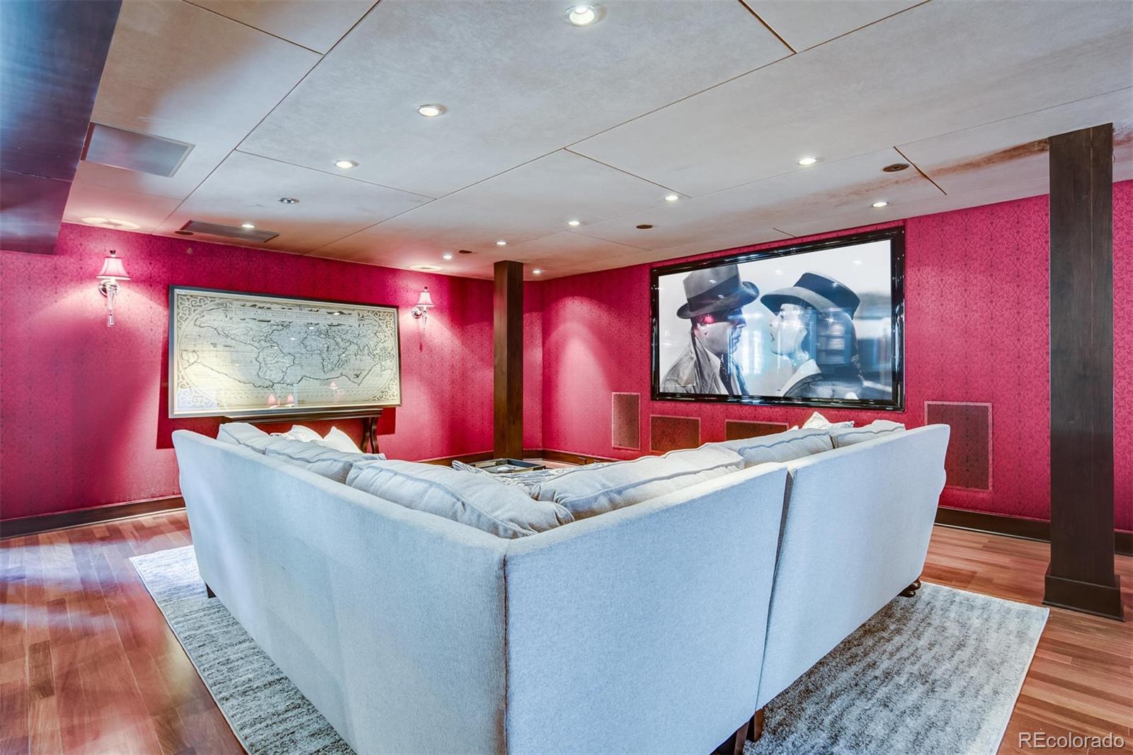 6917 Timbers Drive Evergreen, CO 80439 - Photo 12 of 39 a room with wooden floor a flat screen tv and windows