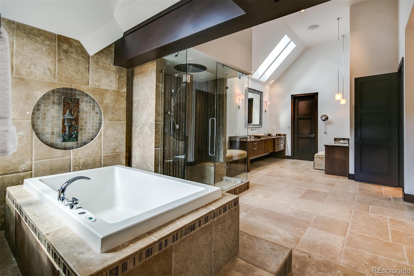 6917 Timbers Drive Evergreen, CO 80439 - Photo 20 of 39 a bathroom with a tub sink and mirror