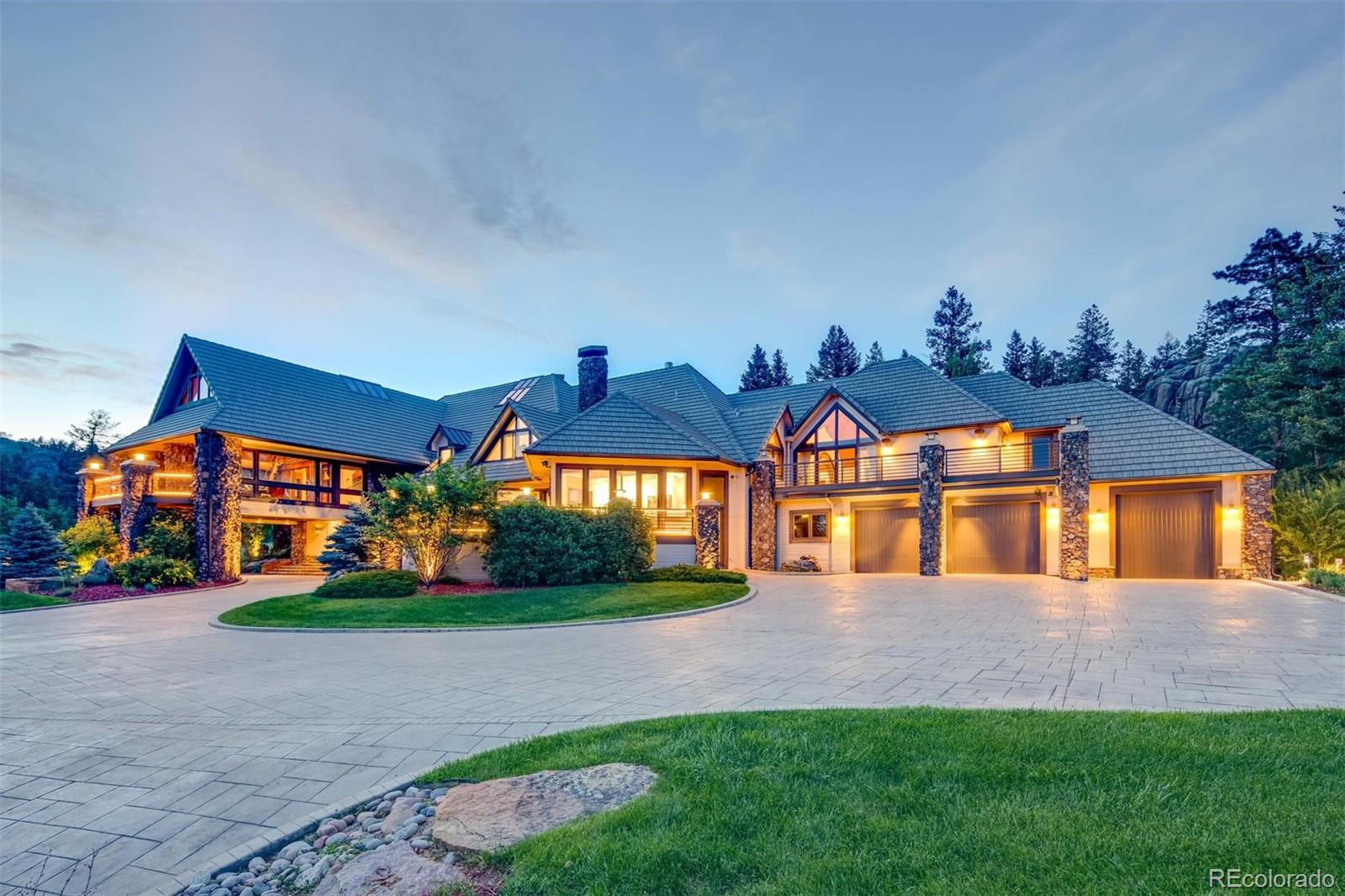 6917 Timbers Drive Evergreen, CO 80439 - Photo 2 of 39 a front view of a house with a yard and potted plants