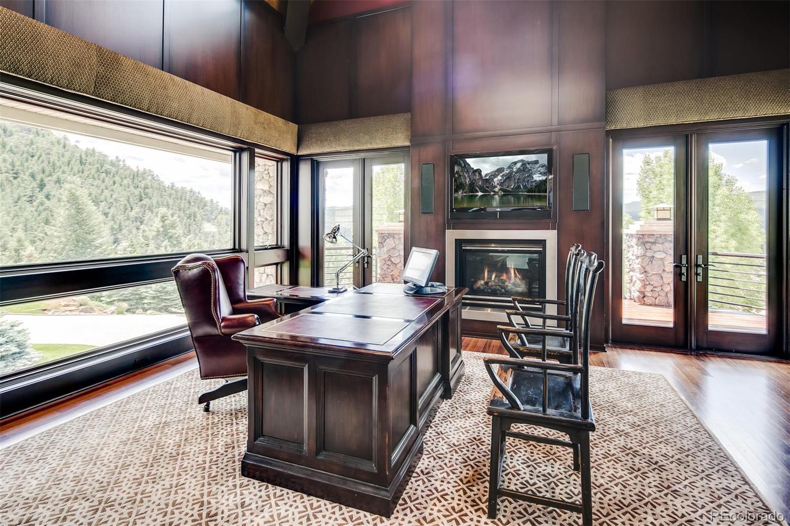 6917 Timbers Drive Evergreen, CO 80439 - Photo 22 of 39 a dinning table sitting in a living room next to a window