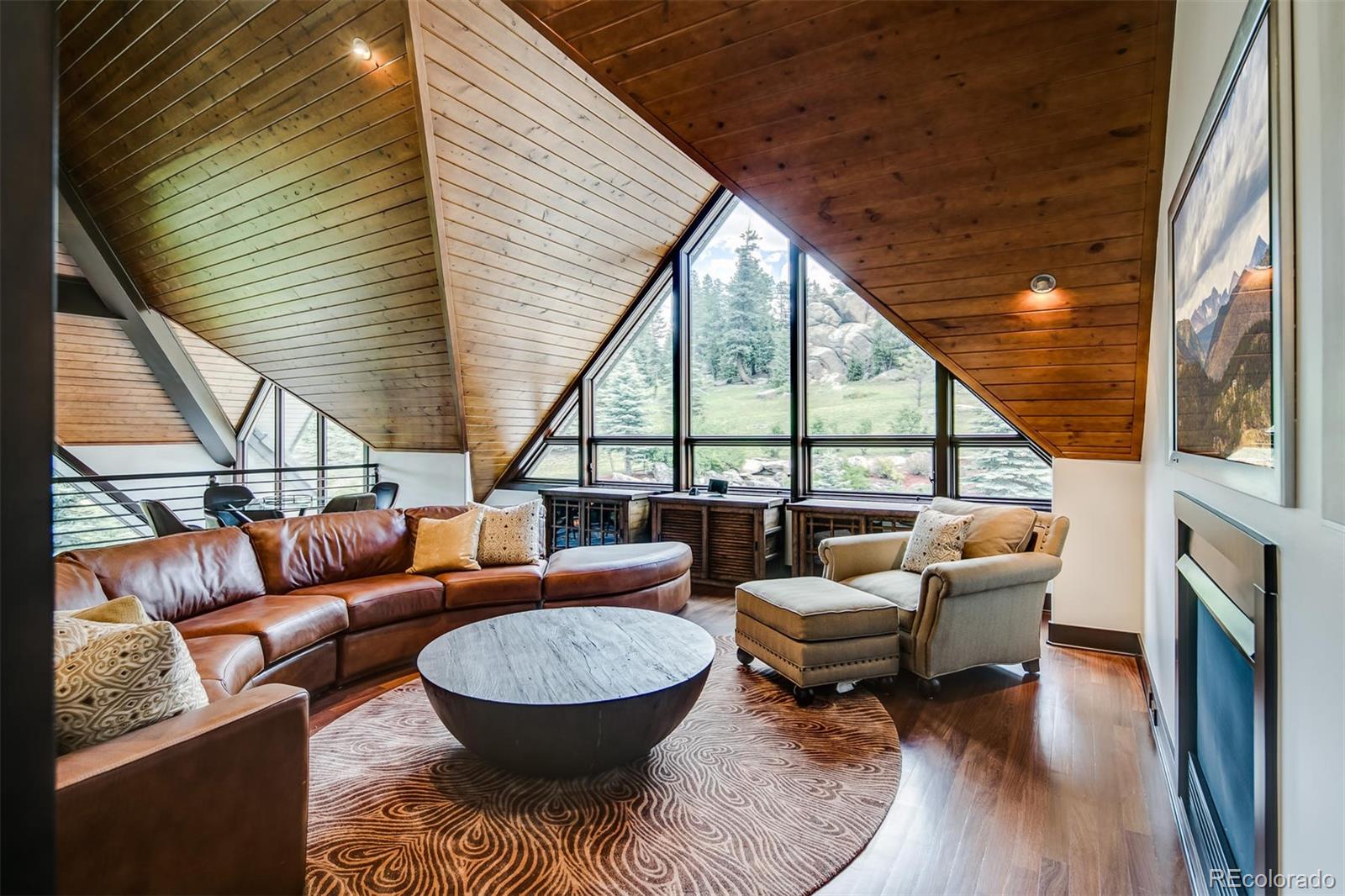 6917 Timbers Drive Evergreen, CO 80439 - Photo 25 of 39 a outdoor living space with patio furniture and a fireplace