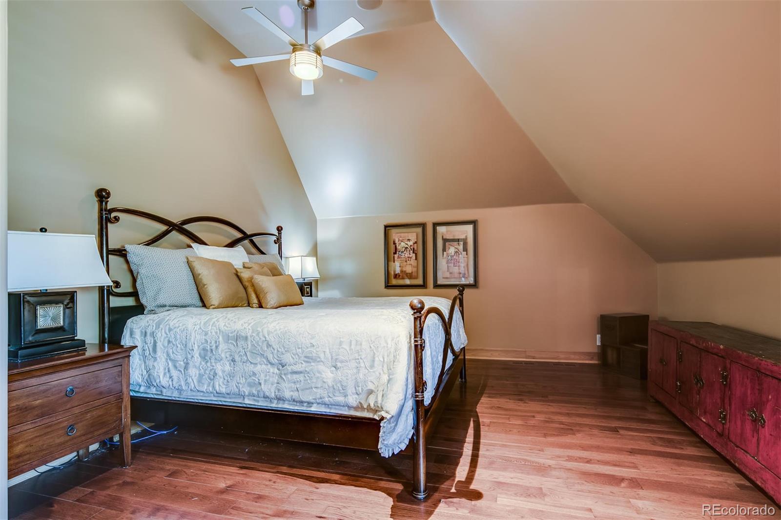 6917 Timbers Drive Evergreen, CO 80439 - Photo 28 of 39 a bedroom with a bed and a chandelier