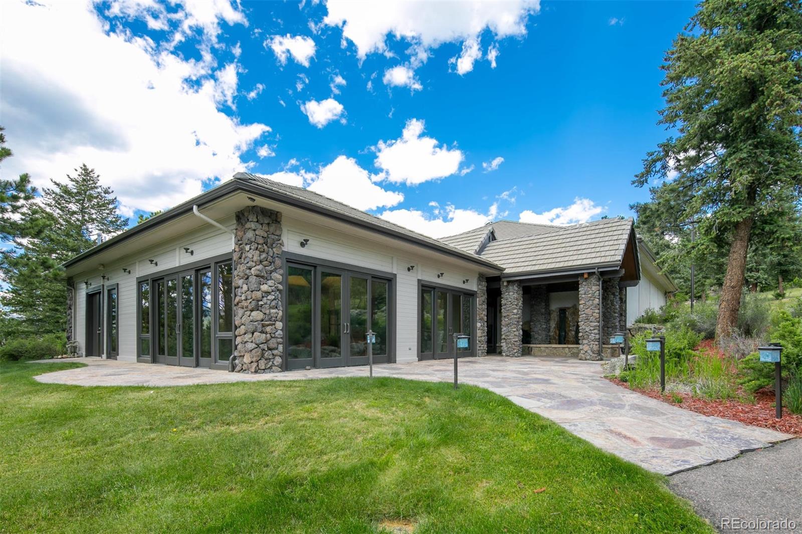 6917 Timbers Drive Evergreen, CO 80439 - Photo 30 of 39 a view of a house with a yard