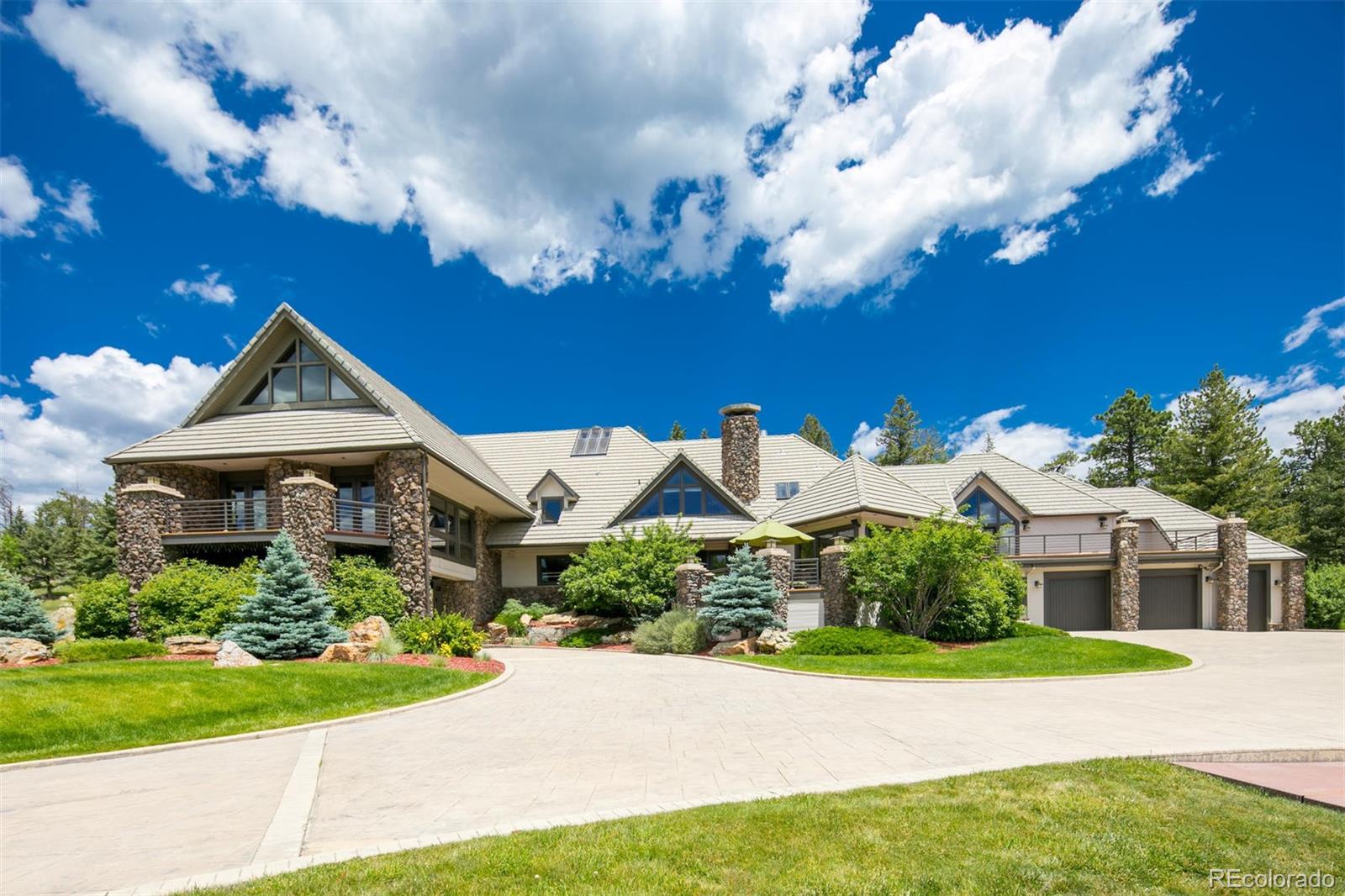 6917 Timbers Drive Evergreen, CO 80439 - Photo 38 of 39 a front view of a house with garden