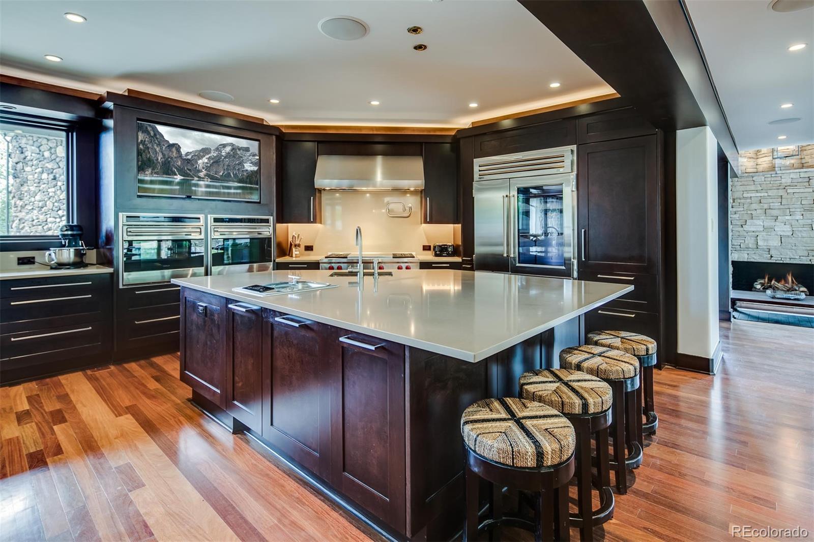 6917 Timbers Drive Evergreen, CO 80439 - Photo 7 of 39 a kitchen with a table chairs stove and wooden floor