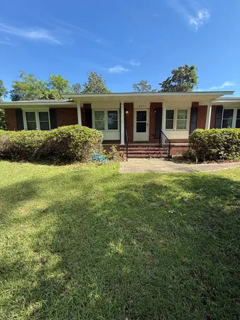 a front view of a house with a yard and porch