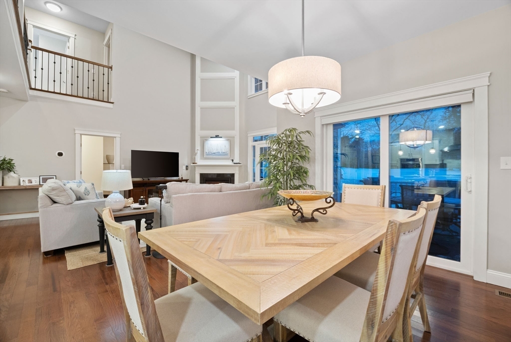 23 Starboard Drive, Unit 50 Wareham, MA 02532 - Photo 17 of 42 a dining room with wooden floor a chandelier a wooden table and chairs