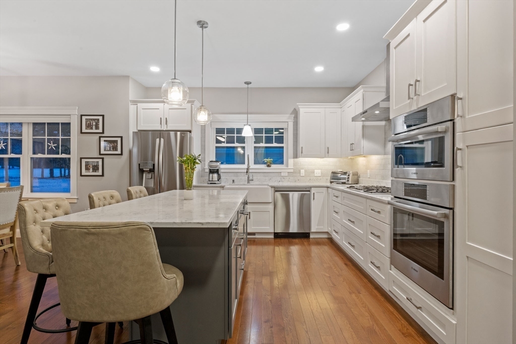 23 Starboard Drive, Unit 50 Wareham, MA 02532 - Photo 3 of 42 a kitchen with stainless steel appliances kitchen island granite countertop a kitchen island hardwood floor sink and stove
