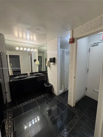 a bathroom with a glass shower door and a sink