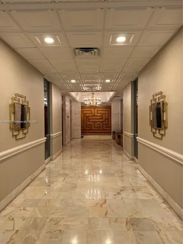 a view of a hallway with a bathroom