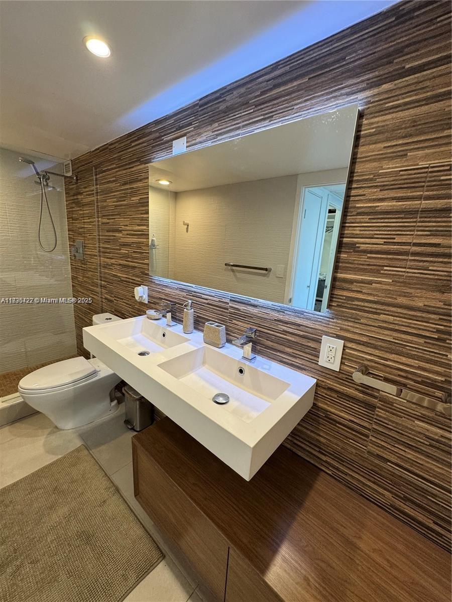 5750 Collins Avenue, Unit 4F Miami Beach, FL 33140 - Photo 23 of 46 a bathroom with a sink and a mirror