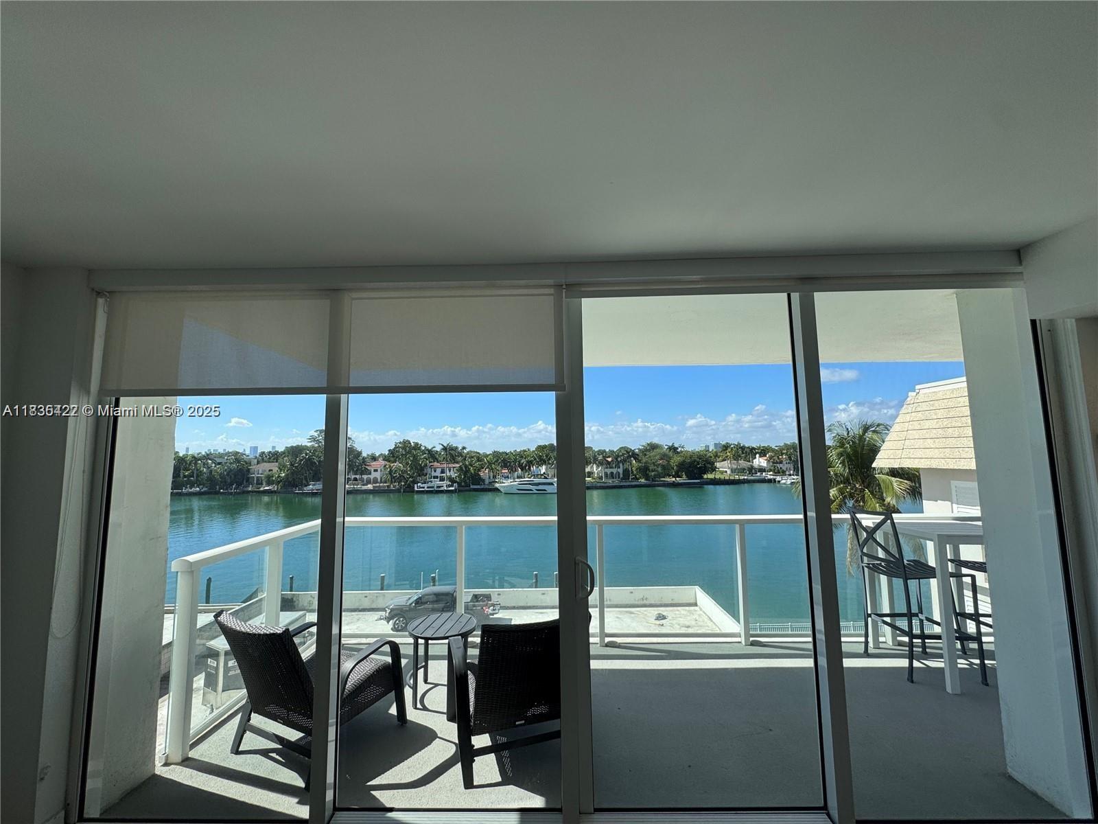 5750 Collins Avenue, Unit 4F Miami Beach, FL 33140 - Photo 32 of 46 a view of a balcony with chair and table in the kitchen