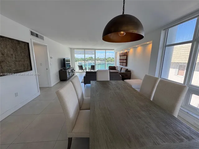 a large kitchen with stainless steel appliances granite countertop a sink and dishwasher a stove top oven with wooden floor