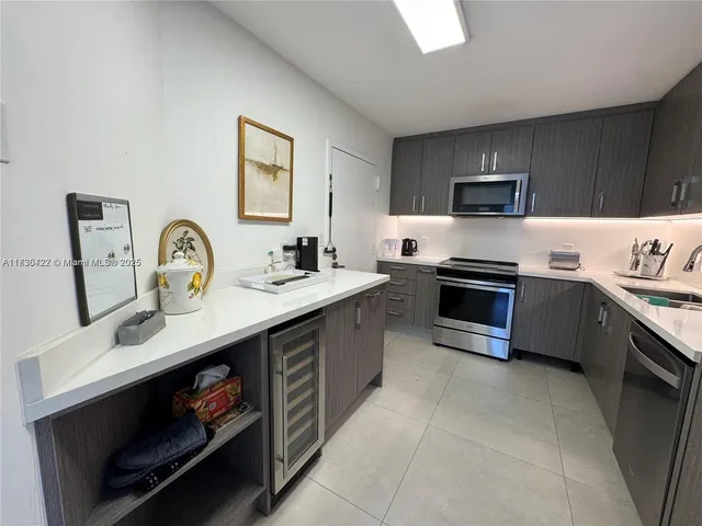 a kitchen with stainless steel appliances granite countertop a refrigerator and a stove