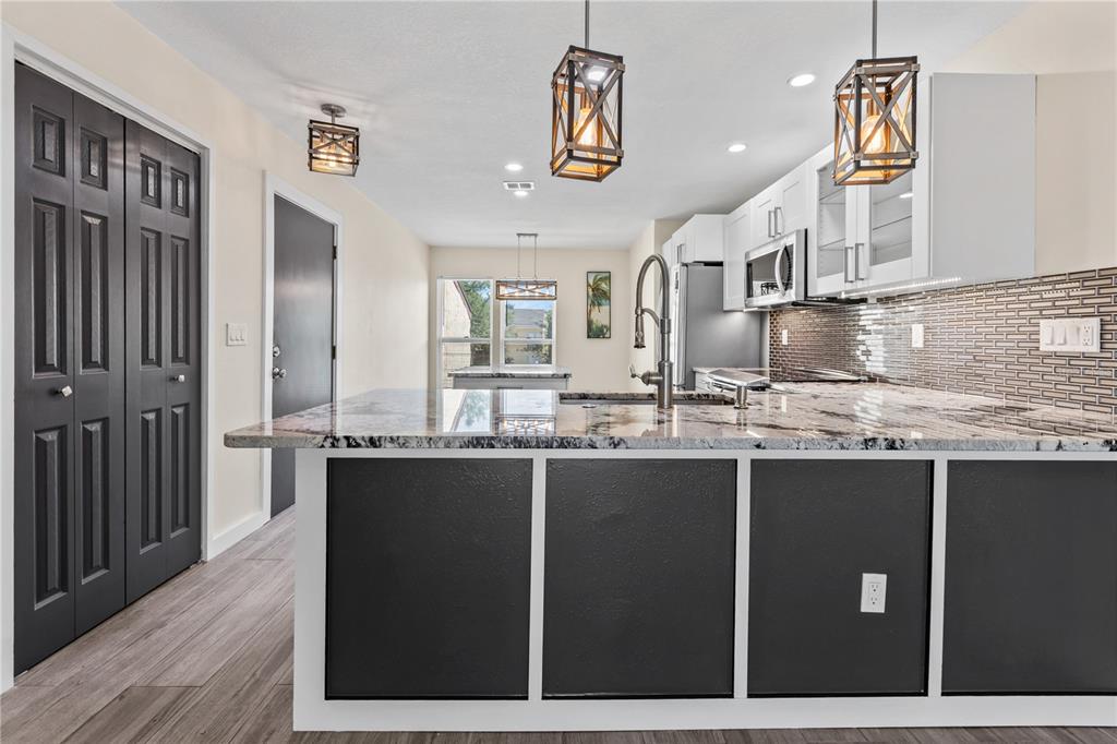 3405 Clark Road, Unit 205 Sarasota, FL 34231 - Photo 6 of 28 a kitchen with stainless steel appliances granite countertop a sink and cabinets