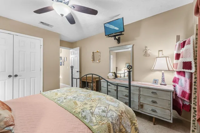 a bedroom with a bed and a dresser