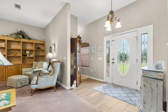 a view of a bedroom with furniture and windows