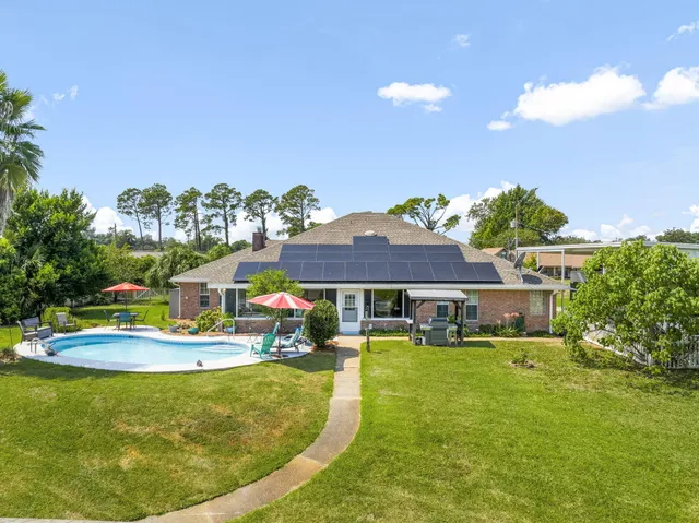 an aerial view of a house with a swimming pool