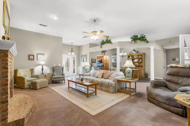 a living room with furniture and a chandelier