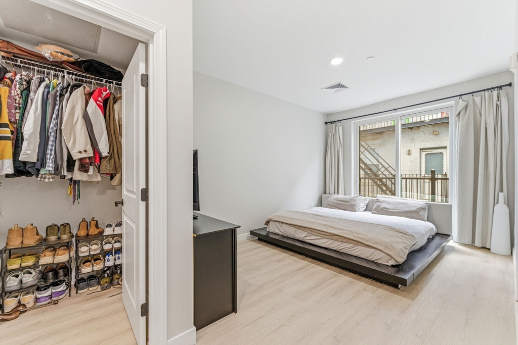 157 Chestnut Street, Unit 203 Chelsea, MA 02150 - Photo 13 of 31 a bedroom with a bed and a window