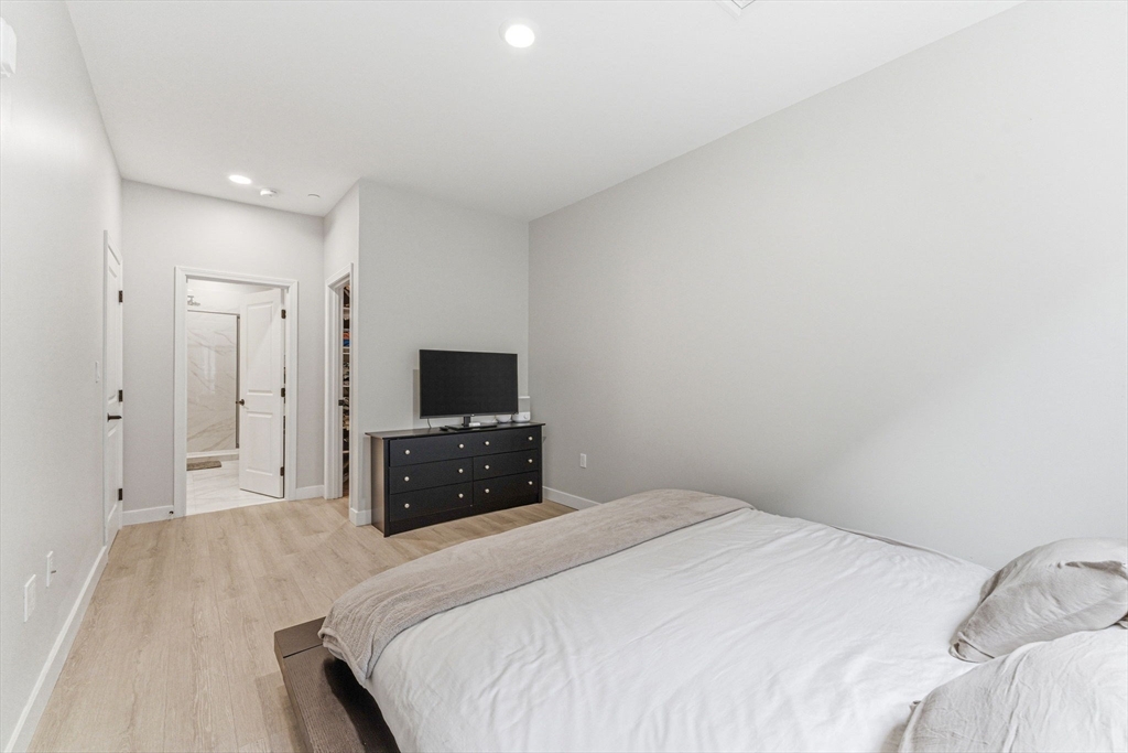 157 Chestnut Street, Unit 203 Chelsea, MA 02150 - Photo 14 of 31 a bedroom with a bed and a flat screen tv