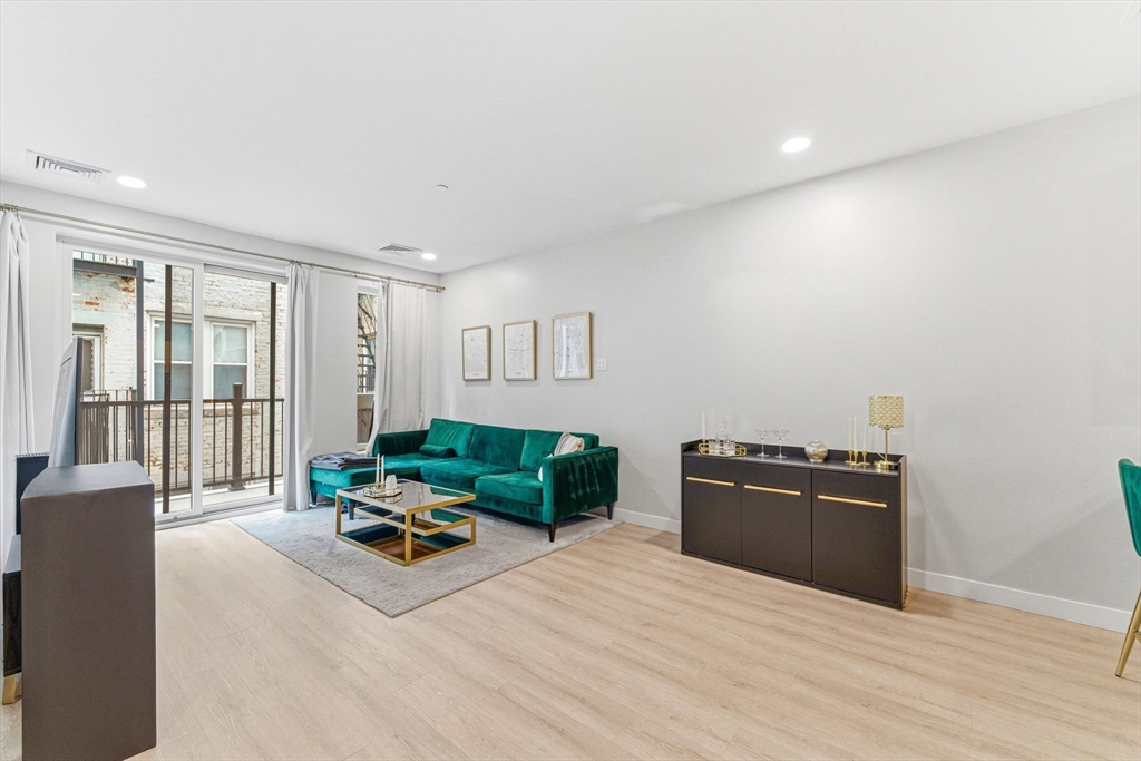157 Chestnut Street, Unit 203 Chelsea, MA 02150 - Photo 5 of 31 a living room with furniture window and wooden floor