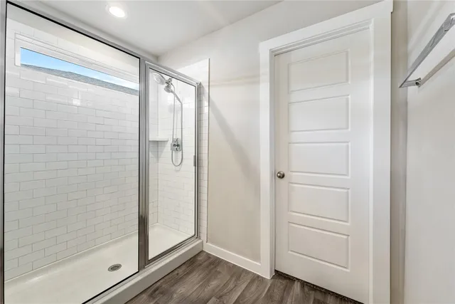 a bathroom with a glass door shower