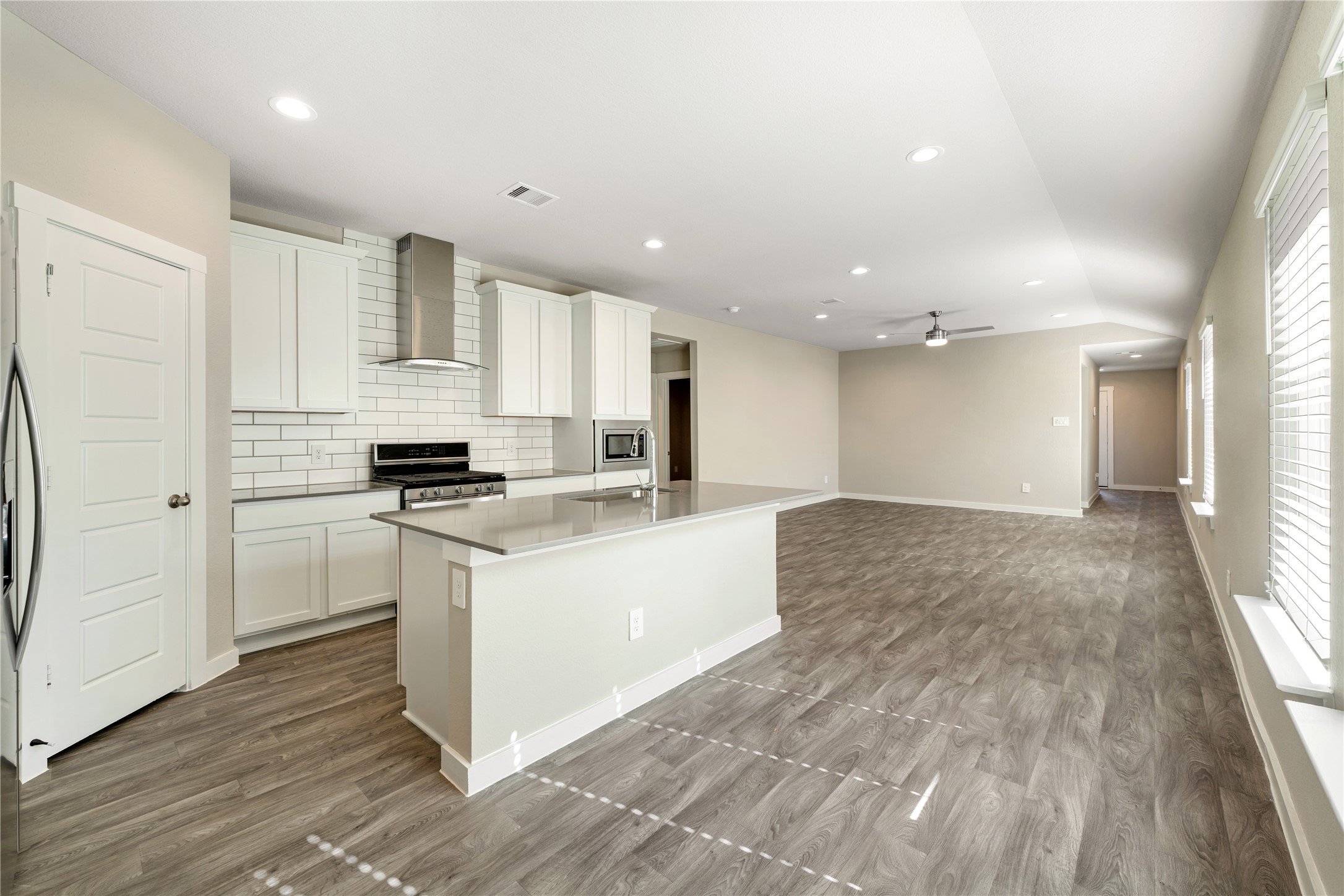 12722 Basinghall Lane Houston, TX 77047 - Photo 4 of 22 a kitchen with white cabinets and appliances