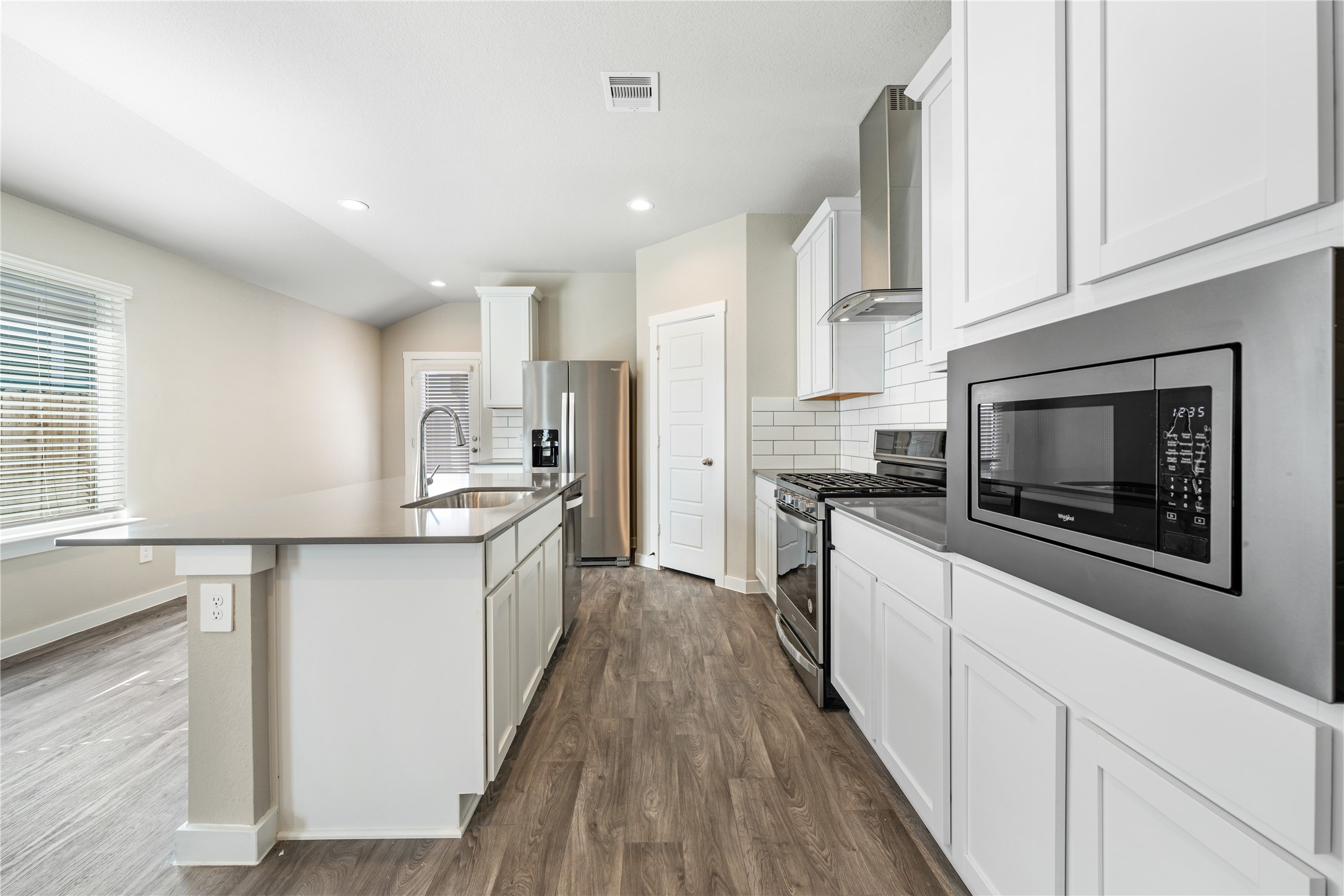 12722 Basinghall Lane Houston, TX 77047 - Photo 6 of 22 a kitchen with granite countertop a sink and steel appliances
