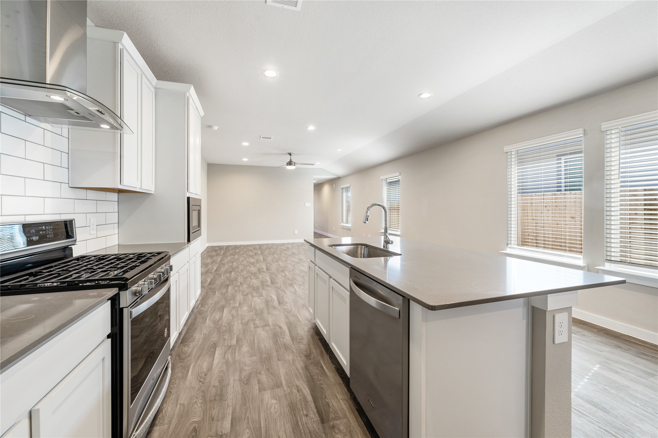 12722 Basinghall Lane Houston, TX 77047 - Photo 9 of 22 a kitchen with stainless steel appliances granite countertop a sink stove and refrigerator