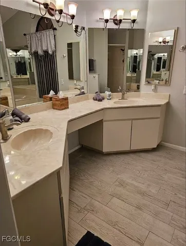 a bathroom with a sink double vanity granite and a mirror