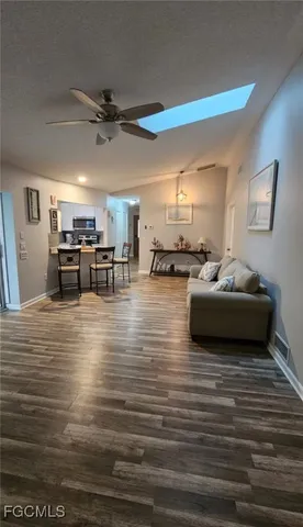 a living room with furniture and kitchen view