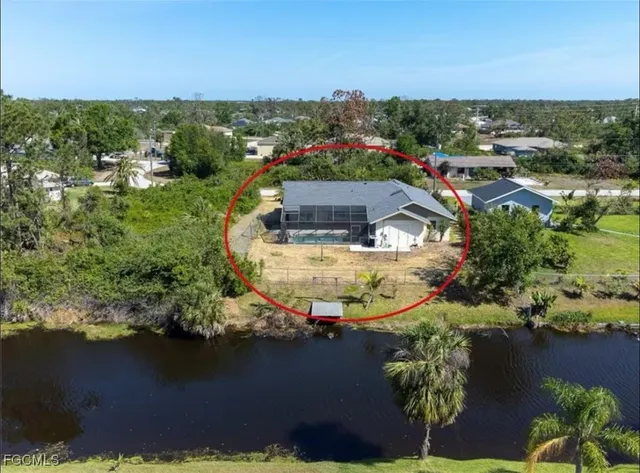 an aerial view of a house with a lake view