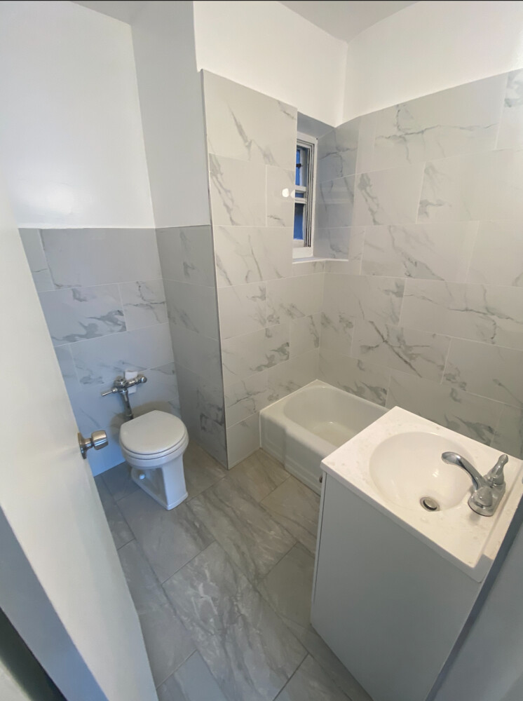 515 East 82nd Street, Unit 5A Manhattan, NY 10028 - Photo 5 of 5 a bathroom with a sink a toilet and a bathtub