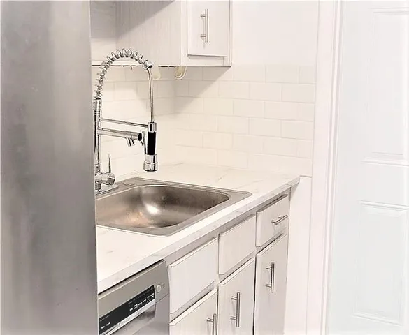 a kitchen with a sink and a refrigerator