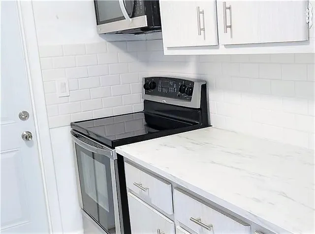 a kitchen with sink and cabinets
