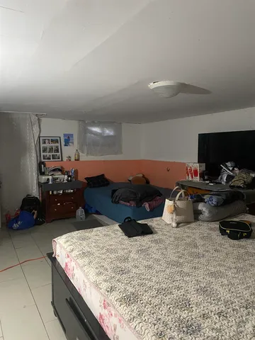 a bed room with furniture and a flat screen tv