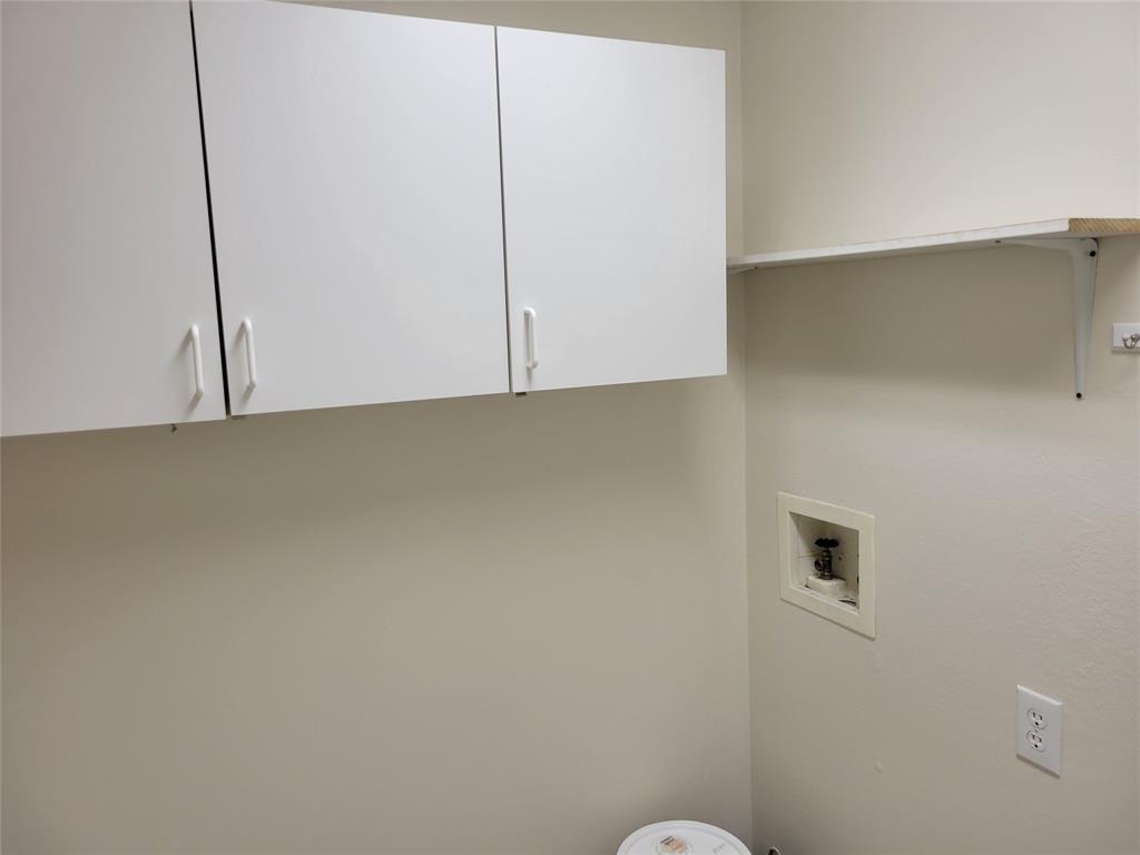 2913 Rush Creek Road McKinney, TX 75072 - Photo 23 of 32 Laundry area with hookup for a washing machine and cabinets