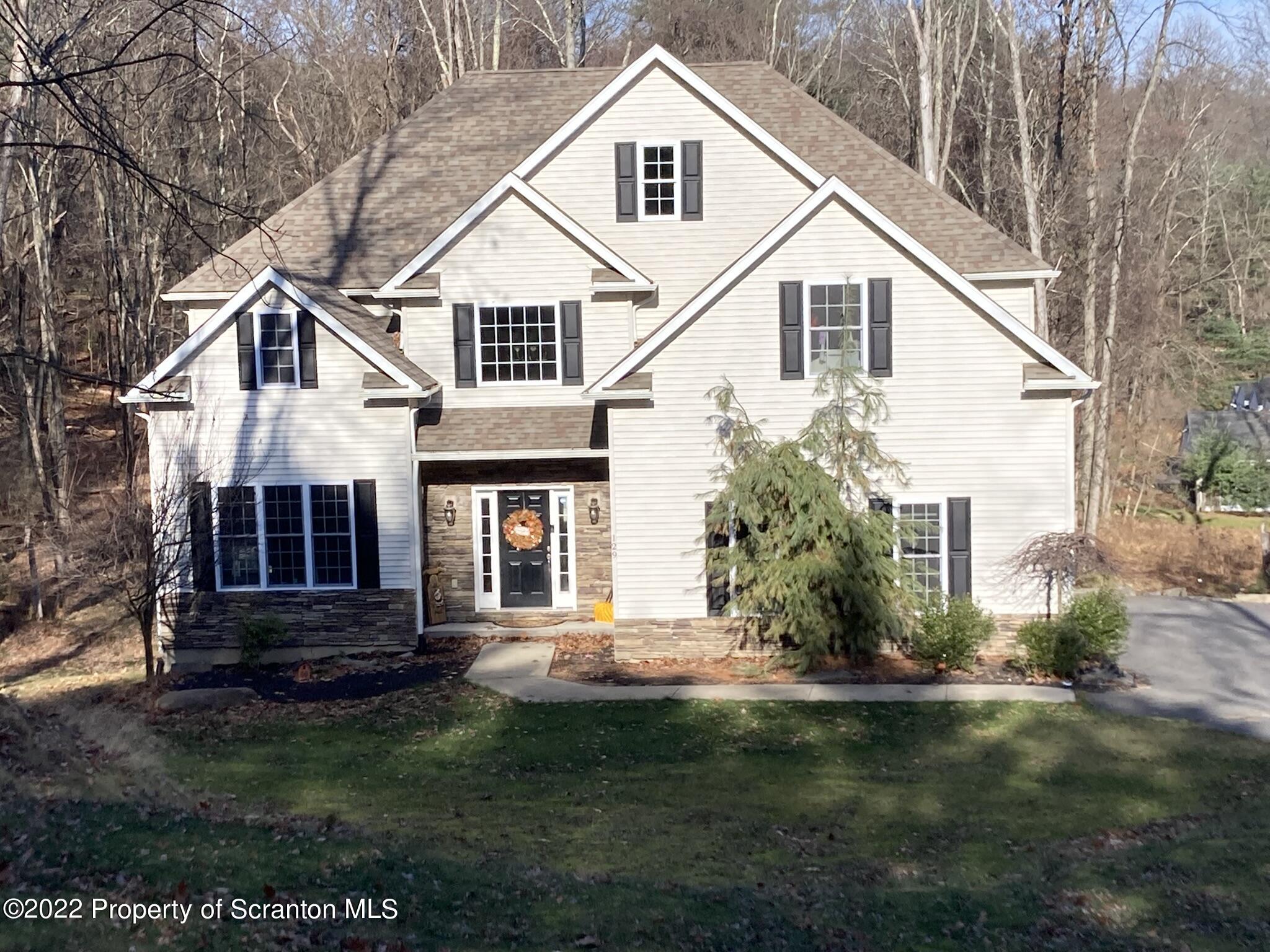 a front view of a house with a garden and porch