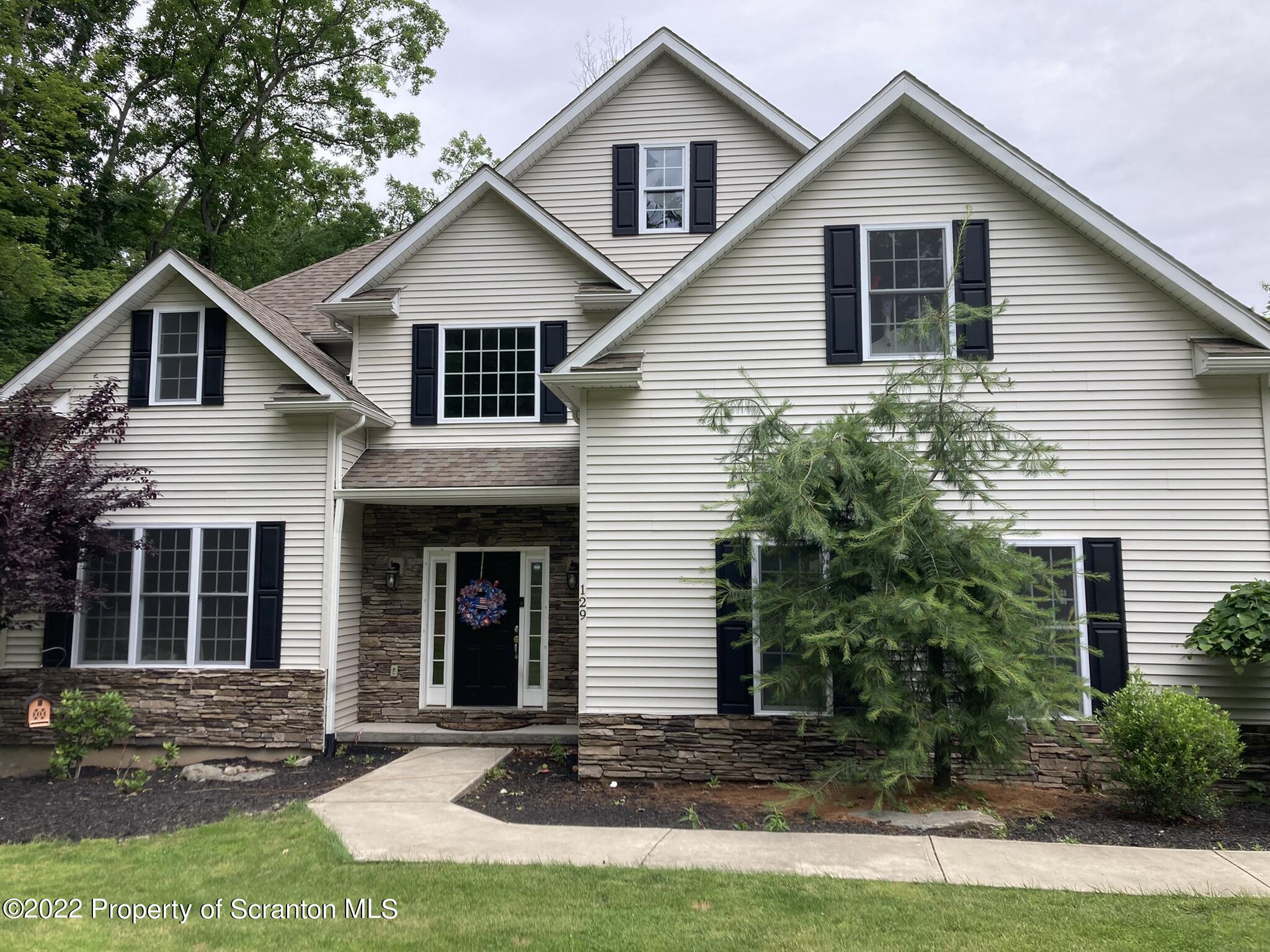 129 Wellington Road Shavertown, PA 18708 - Photo 4 of 16 a front view of a house with a yard
