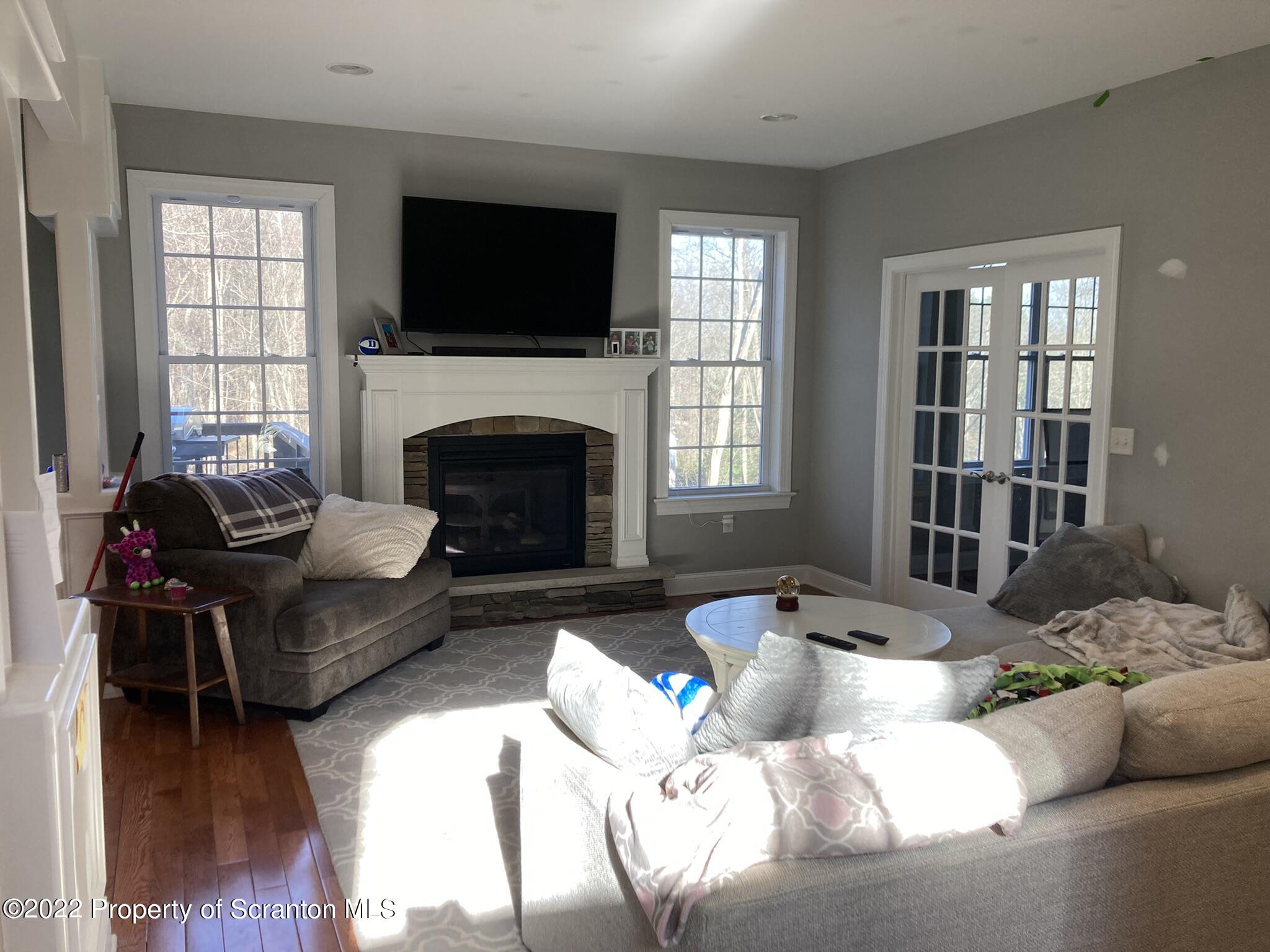 129 Wellington Road Shavertown, PA 18708 - Photo 6 of 16 a living room with furniture fireplace and a flat screen tv