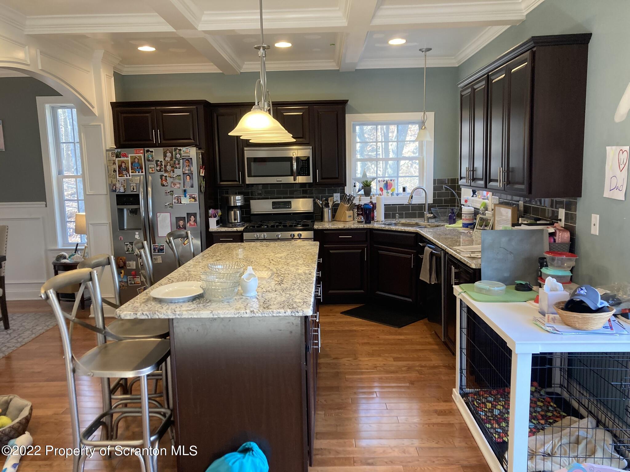 129 Wellington Road Shavertown, PA 18708 - Photo 7 of 16 a kitchen with stainless steel appliances granite countertop a kitchen island hardwood floor sink stove dining table and chairs