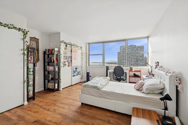 a bedroom with a bed and a large window