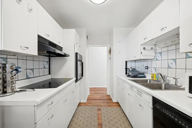 a kitchen with sink cabinets and window
